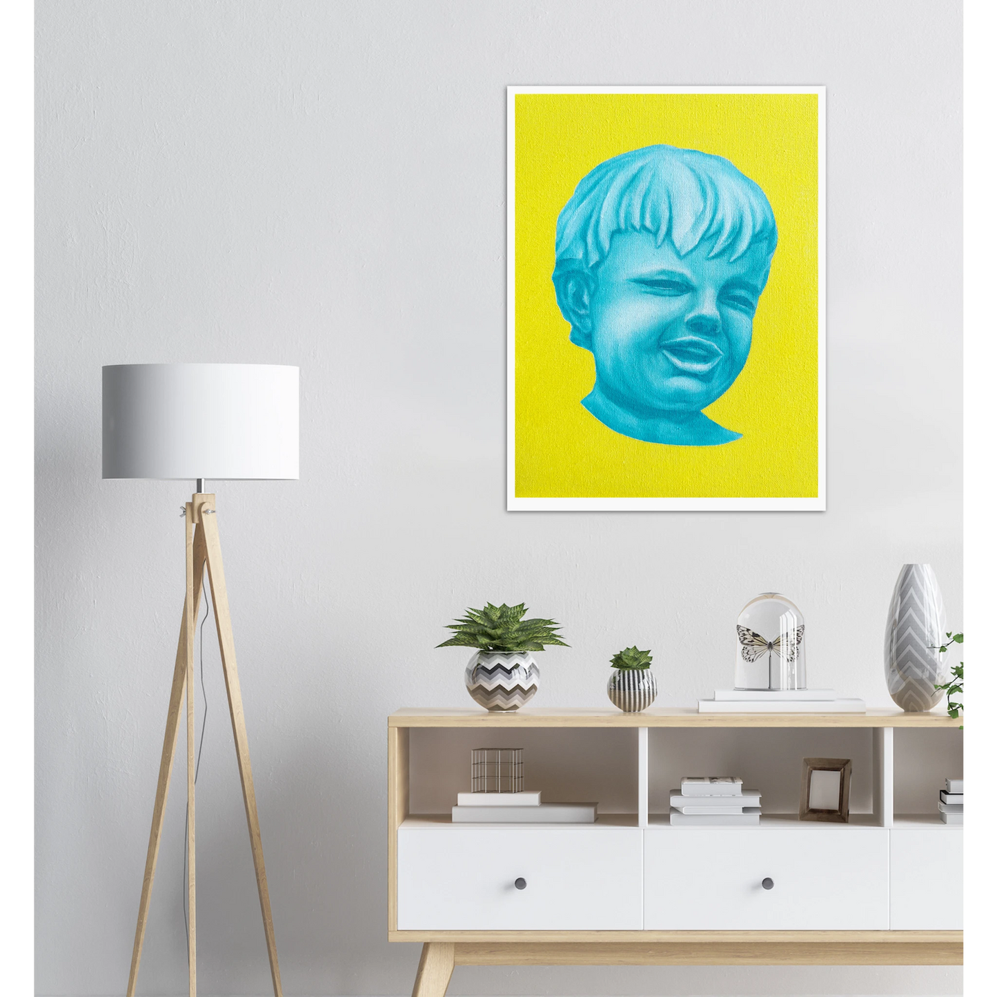 Artwork of a blue face on a yellow background in a modern living room.