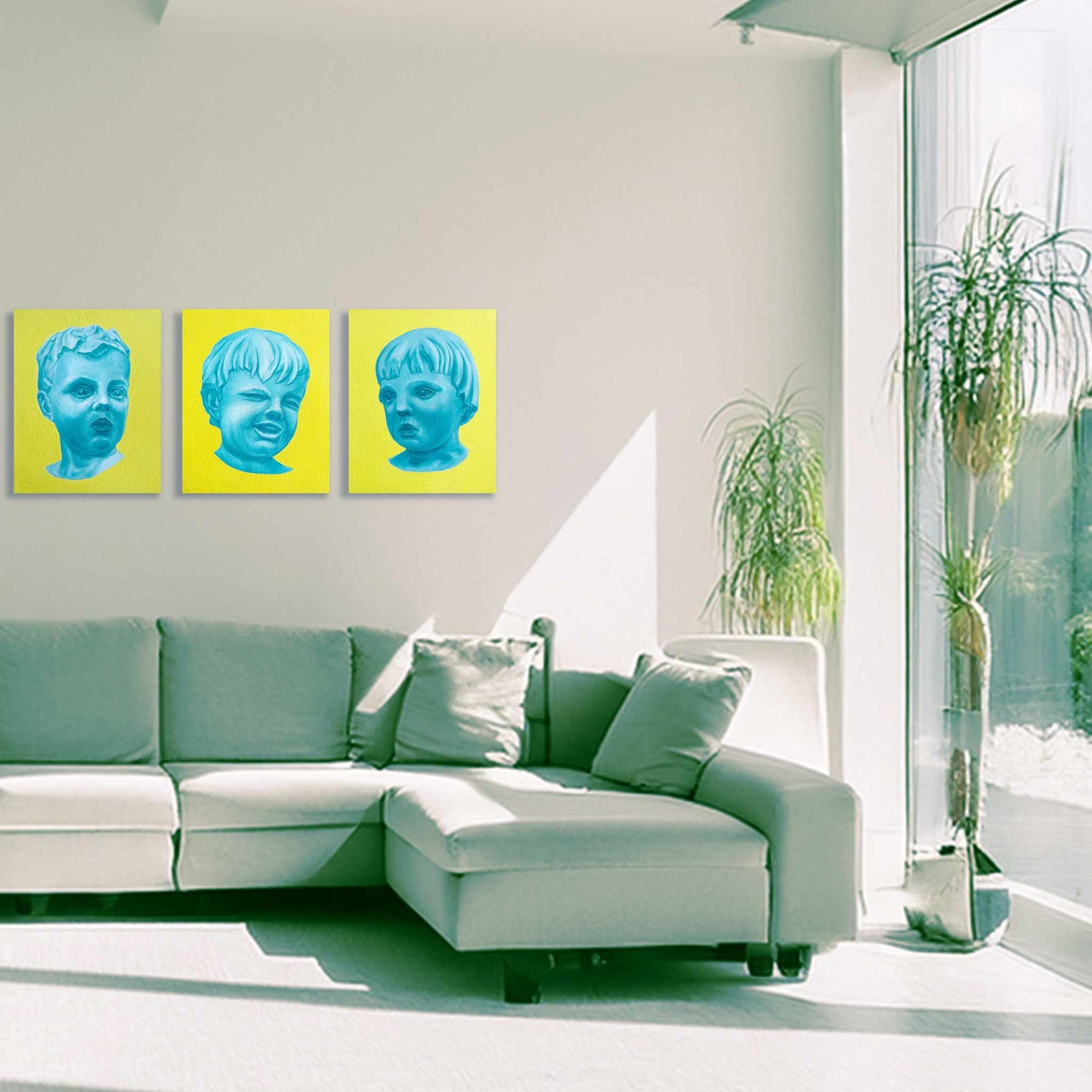 Modern living room with a white sectional sofa, green cushions, and three yellow artworks on the wall.