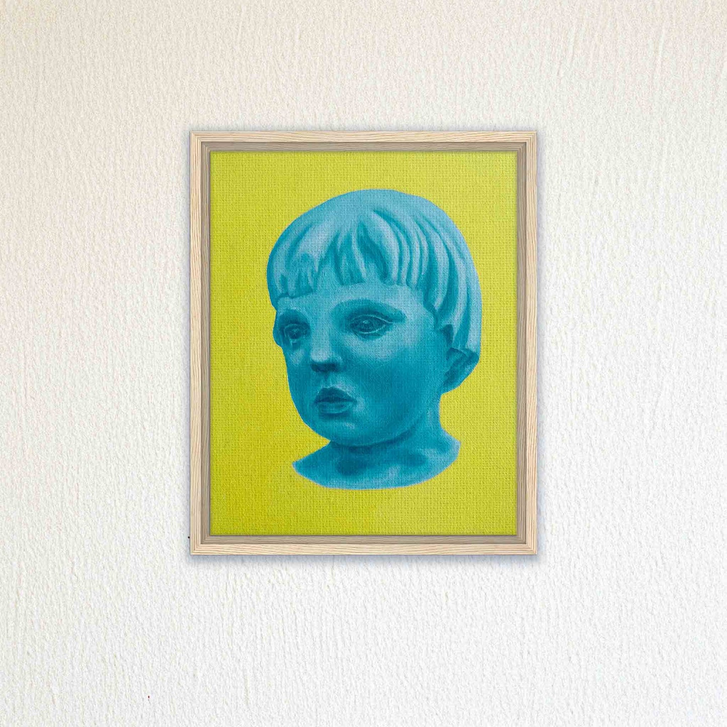 Framed artwork of a blue portrait of a child on a yellow background