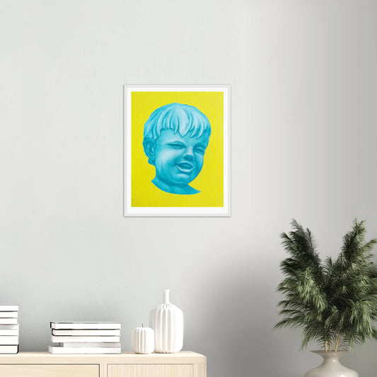 Framed artwork of a blue face on a yellow background in a room with decor elements.