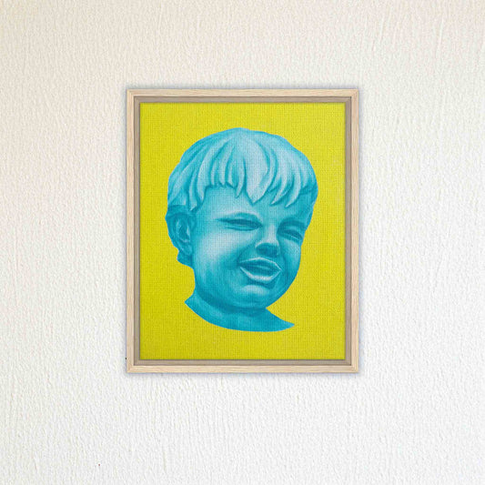 Framed artwork of a blue face on a yellow background, mounted on a textured white wall.