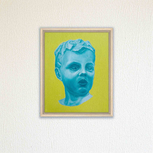 Framed artwork of a blue bust on a green background, mounted on a textured white wall.