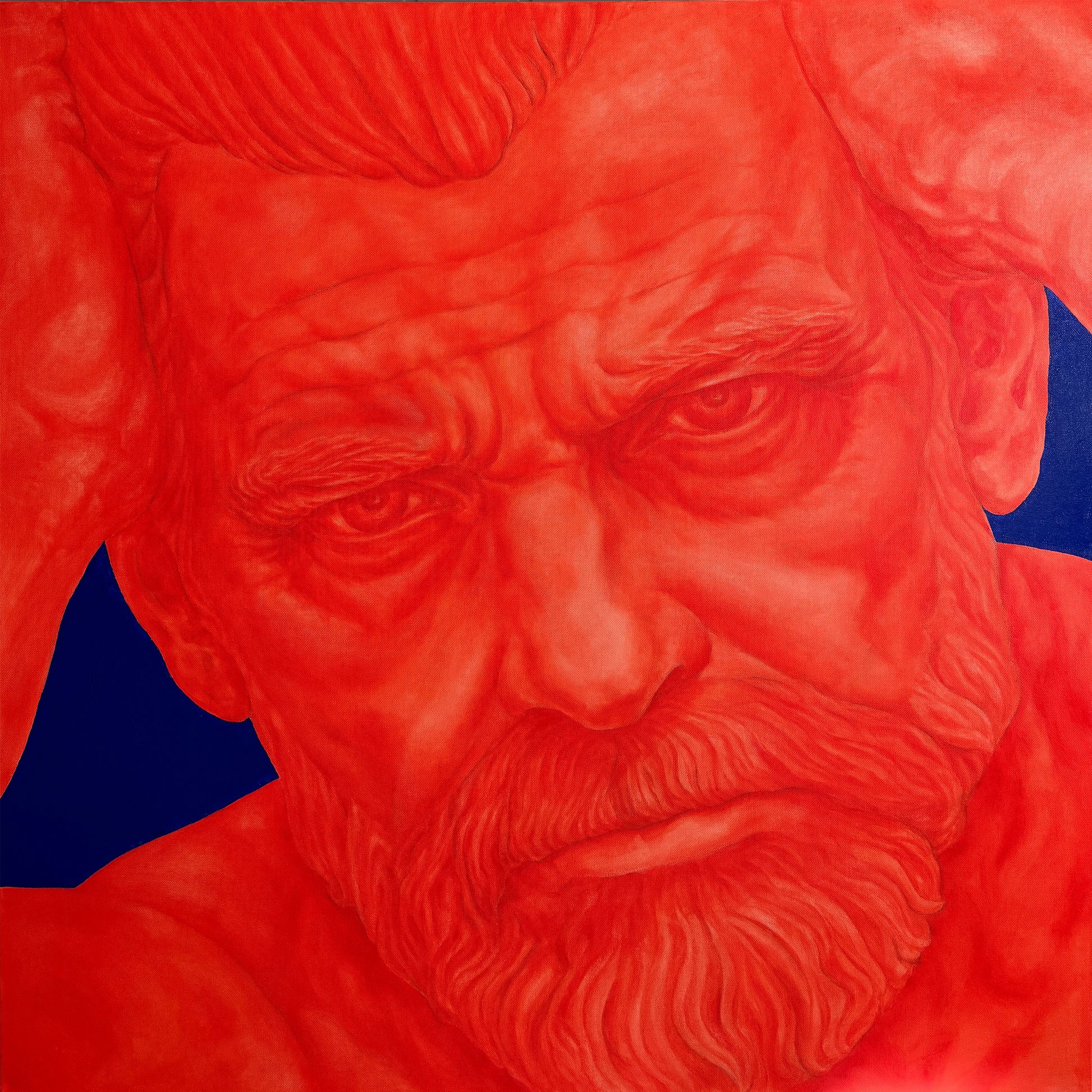 A close-up portrait artwork of a muscular bearded man's face rendered almost entirely in vivid red, with dark blue shapes visible behind the ears and shoulders.