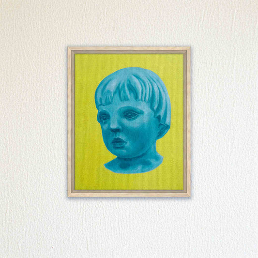 Framed artwork of a blue portrait of a child on a yellow background